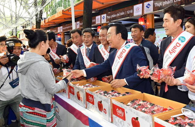 ▲ 김관용 경북도지사가 9·23공원에서 행사 전 기간 운영되는 `바자르`에서 경북 사과 등 농특산물을 현지인들에게 소개하고 있다.<br /><br />
