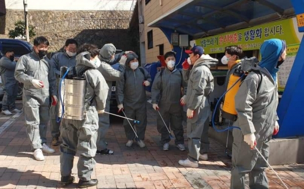 울릉청년단원들이 버스정류장을 방역하고 있다.