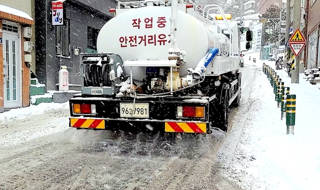 제설차가 지나가면 곧 이어 바닷물을 실은 살수차가 바닷물을 뿌린다.