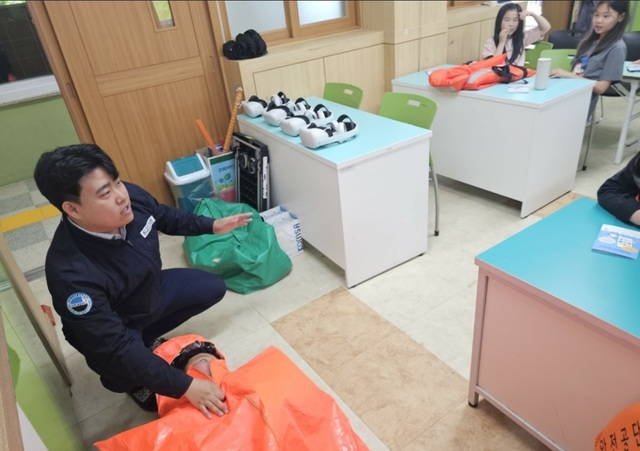울릉도 현장체험할 학생들에게 구명조끼 착용 법 등 안전에 대해 설명하고 있다./포항운항관리센터