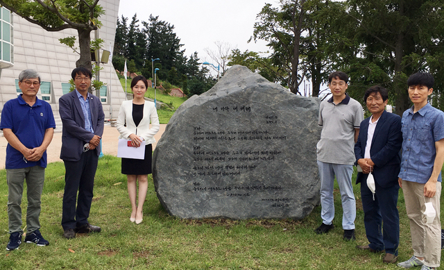 김남일 경북문화관광공사사장(오른쪽에서 세번째)과 김윤배 울릉도독도해양연구기지대장(왼쪽에서 두번째)가 노래비 앞에서 기념촬영을 하고 있다. /경북문화관광공사